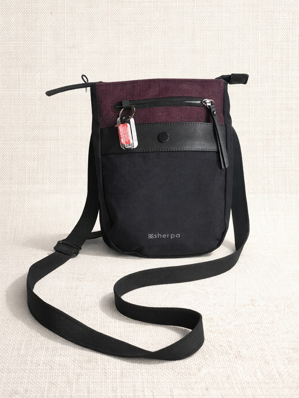 Sherpani Prima AT mini crossbody bag featuring a two-tone design with Merlot